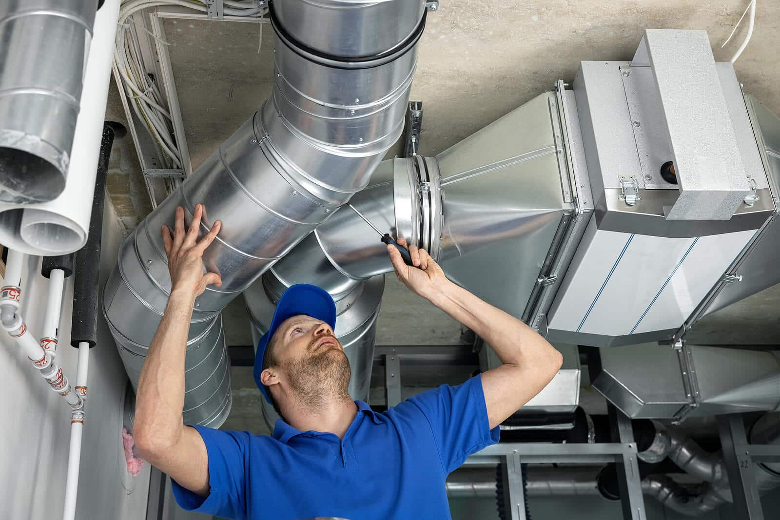 HVAC technician inspecting and repairing air ducts in Fair Oaks