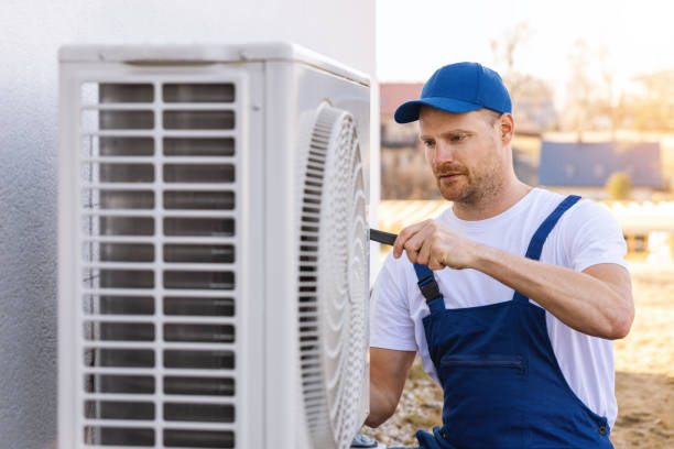 HVAC technician servicing an outdoor air conditioner in Fair Oaks